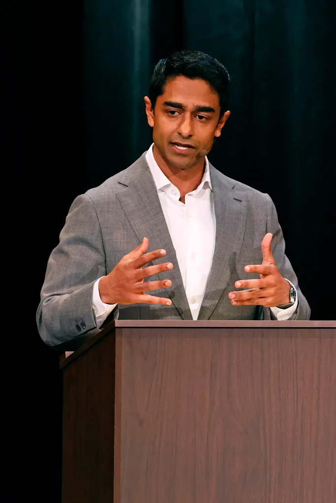 Saikat Chakrabarti speaking at a podium.