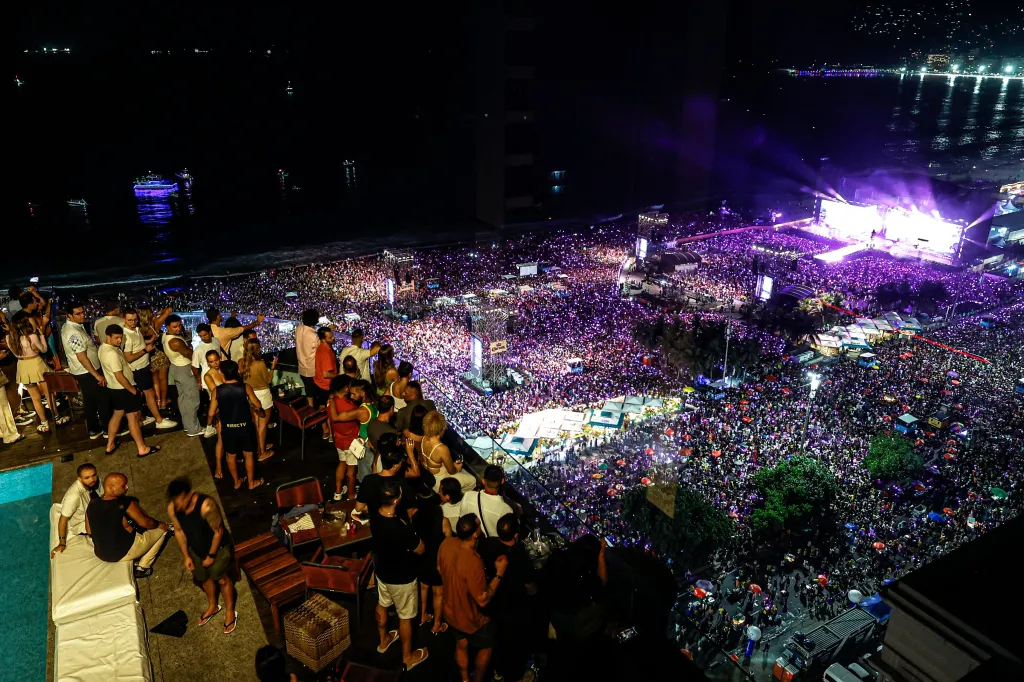 People gathered on Copacabana Beach and on a terrace overlook a free concert by Shakira.