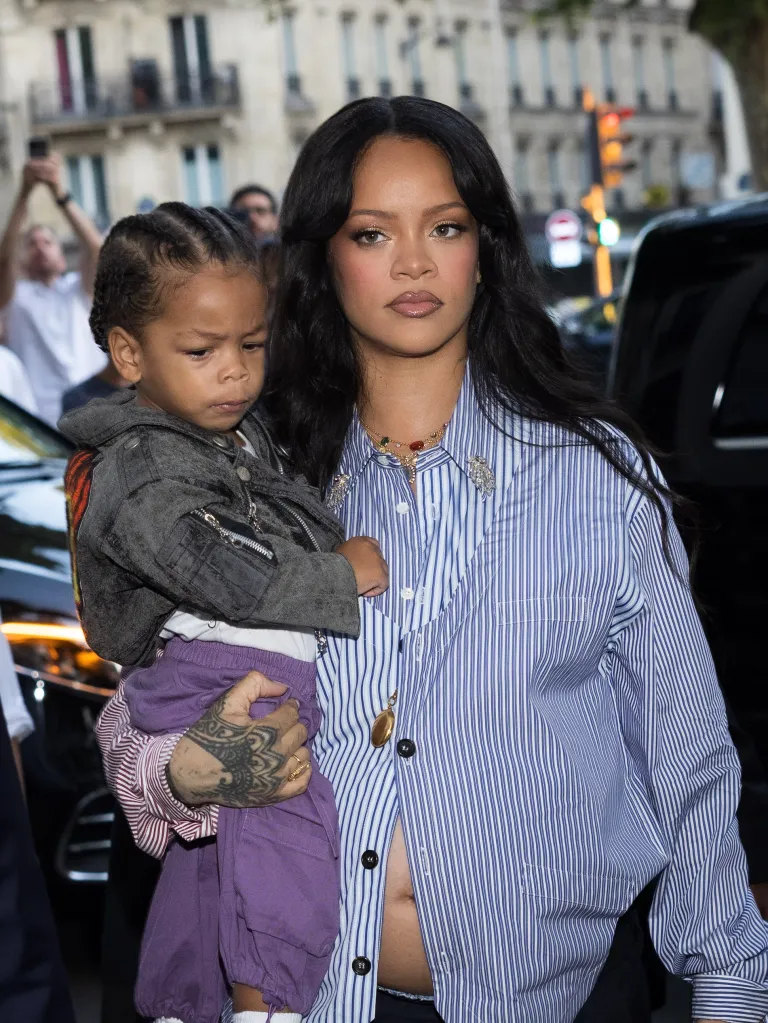 Rihanna holds her son, Riot, while attending the AWGE Menswear Spring/Summer 2026 show during Paris Fashion Week.