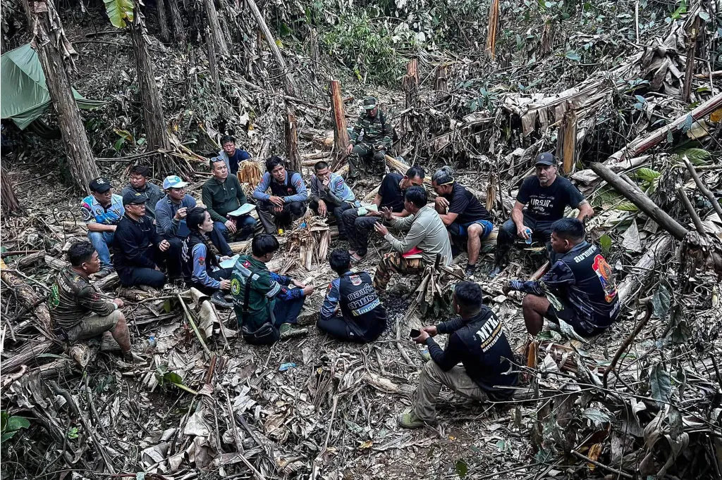 Rescue workers gathered near a cave in Xaisomboun province to discuss search efforts.