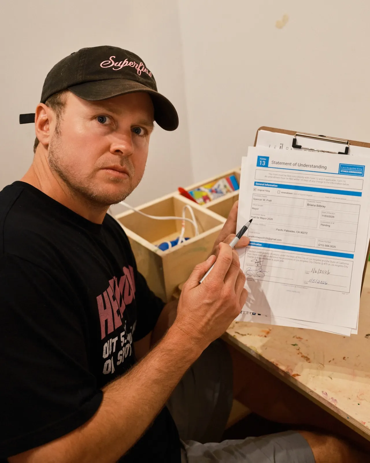 Spencer Pratt holding a Statement of Understanding form for his mayoral run.