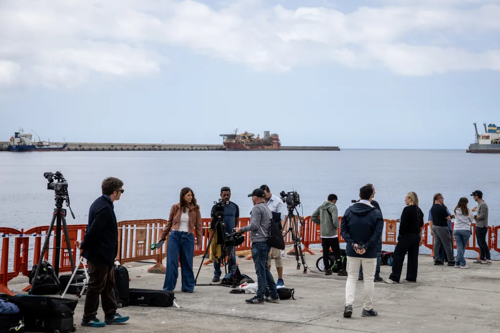 Members of the press and film crew gather at Granadilla Port in Tenerife.