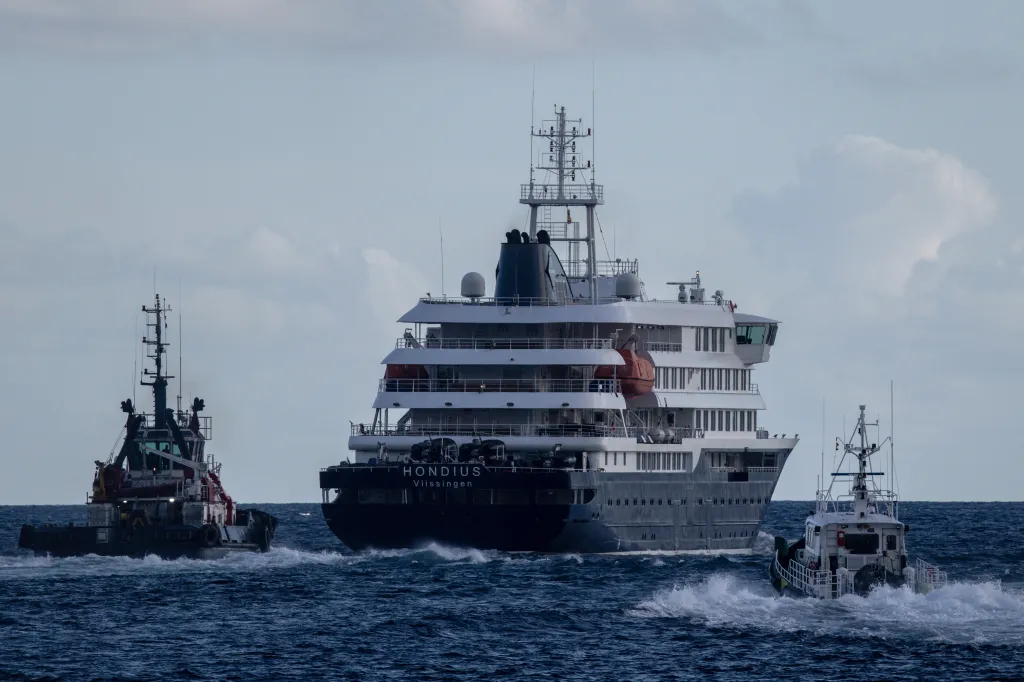 Port vessels accompany the MV Hondius as it departs the Granadilla Port after all passengers were evacuated on May 11, 2026 in Tenerife, part of the Canary Islands, Spain.