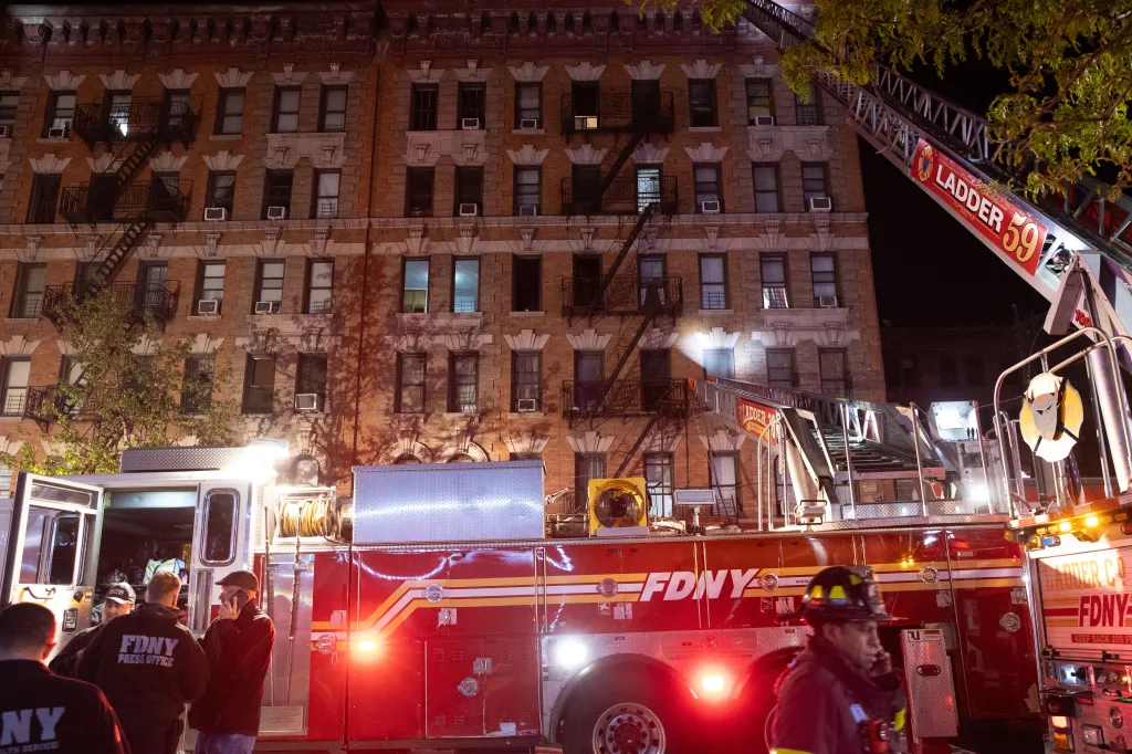 Firefighters operating at a three-alarm fire in a building.