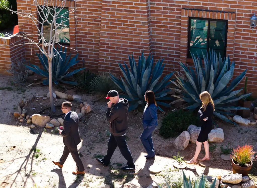 Investigators walking outside the residence of Nancy Guthrie.