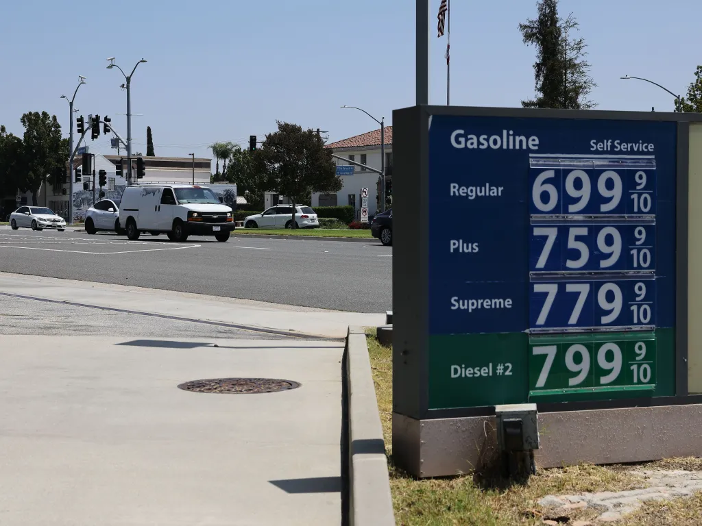 A gas station sign shows record-high prices, with regular gasoline at $6.99, plus at $7.59, supreme at $7.79, and diesel at $7.99 per gallon.