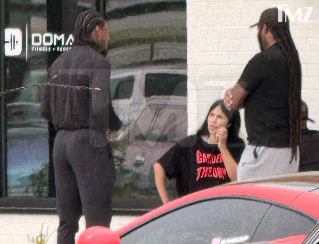 Cardi B and Stefon Diggs outside a cafe.