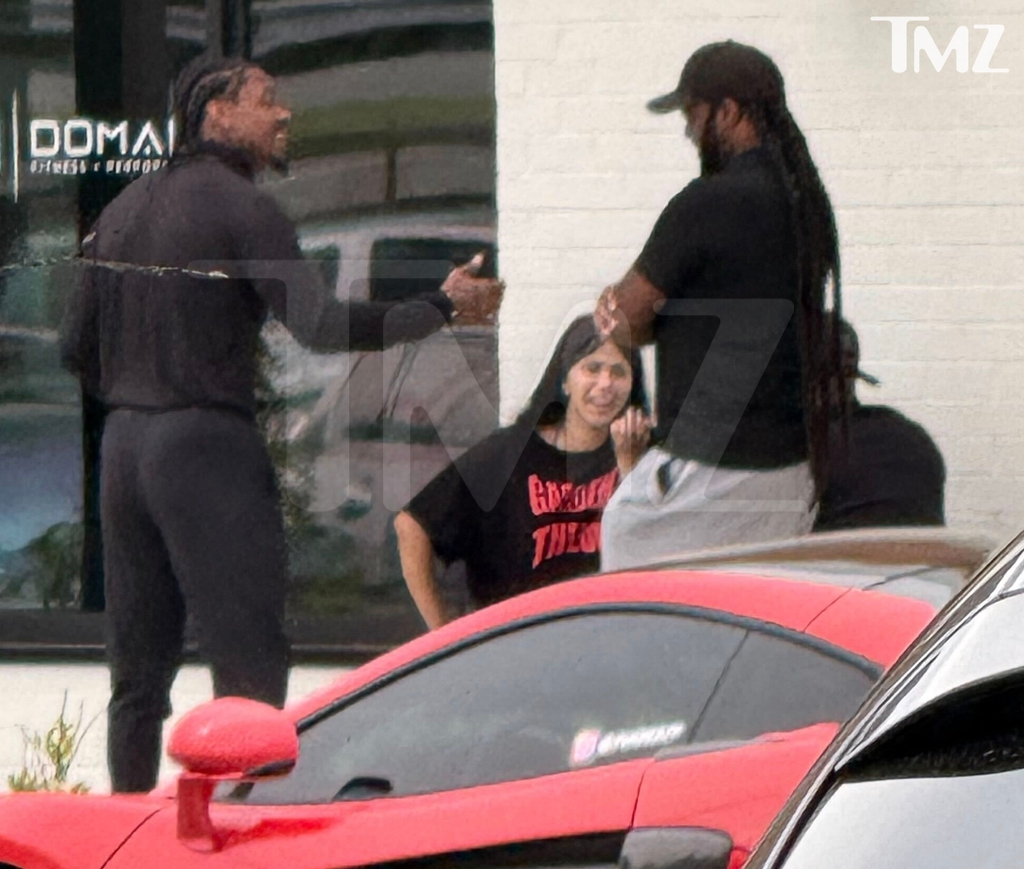 Cardi B and Stefon Diggs outside a cafe.