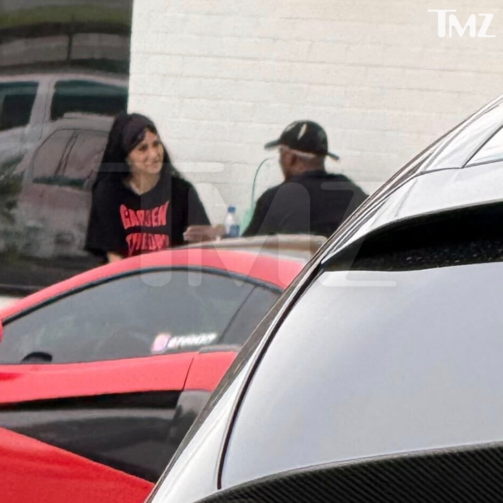 Cardi B and Stefon Diggs outside a cafe.