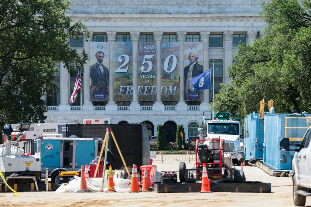 Construction site in front of the USDA building with banners celebrating 