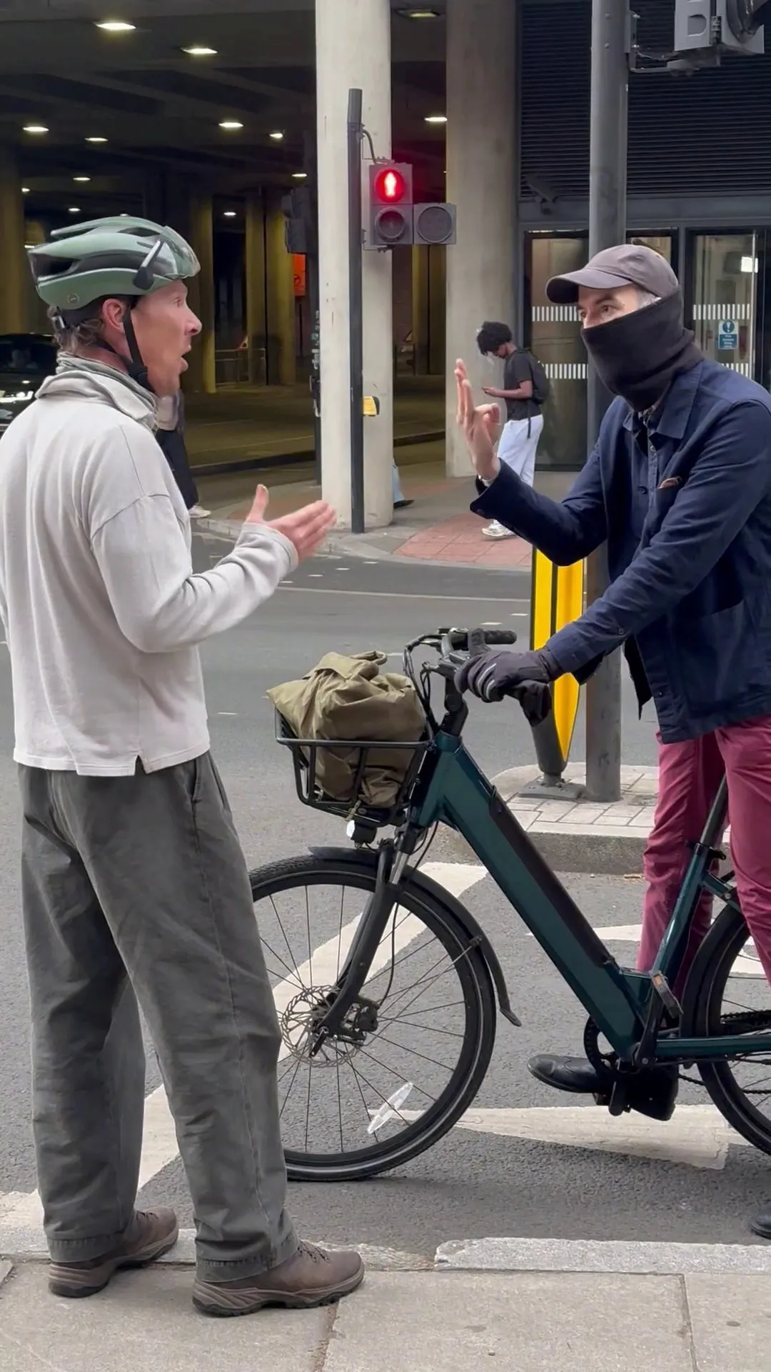 Benedict Cumberbatch in an altercation with a cyclist while standing by his bike.