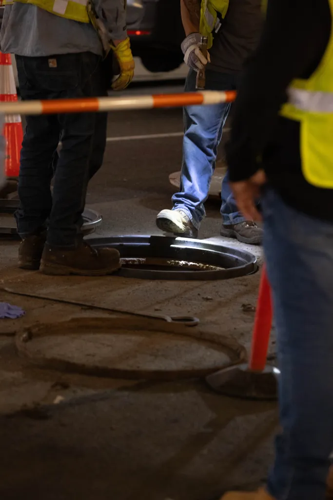 Con Edison workers investigating a manhole.