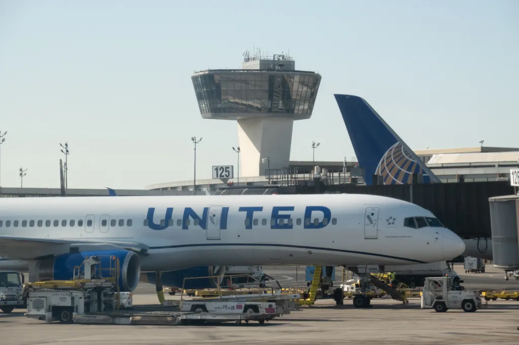 United Airlines planes at Newark Liberty International Airport with the control tower in the background.