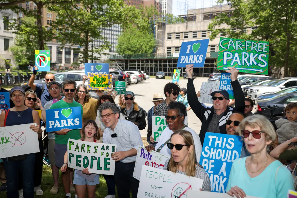 People protesting to turn Columbus Park into a car-free park.
