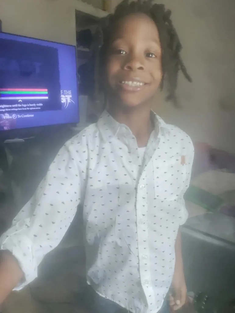 Photo of De'Neil Moses Timberlake, a 5-year-old boy, smiling.