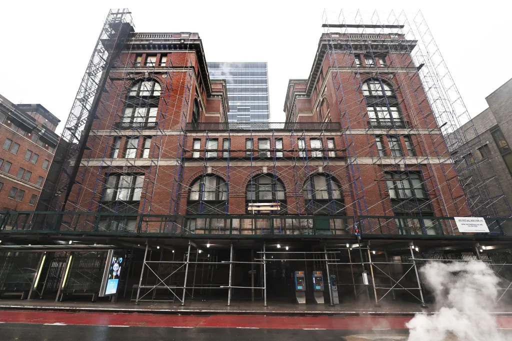 The Bellevue Men's Shelter, a large brick building on First Ave and East 30th St., covered in scaffolding.