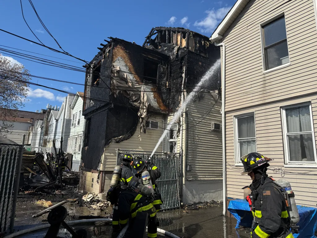 Firefighters battling a multi-alarm fire at 26-26 93rd Street in Queens.