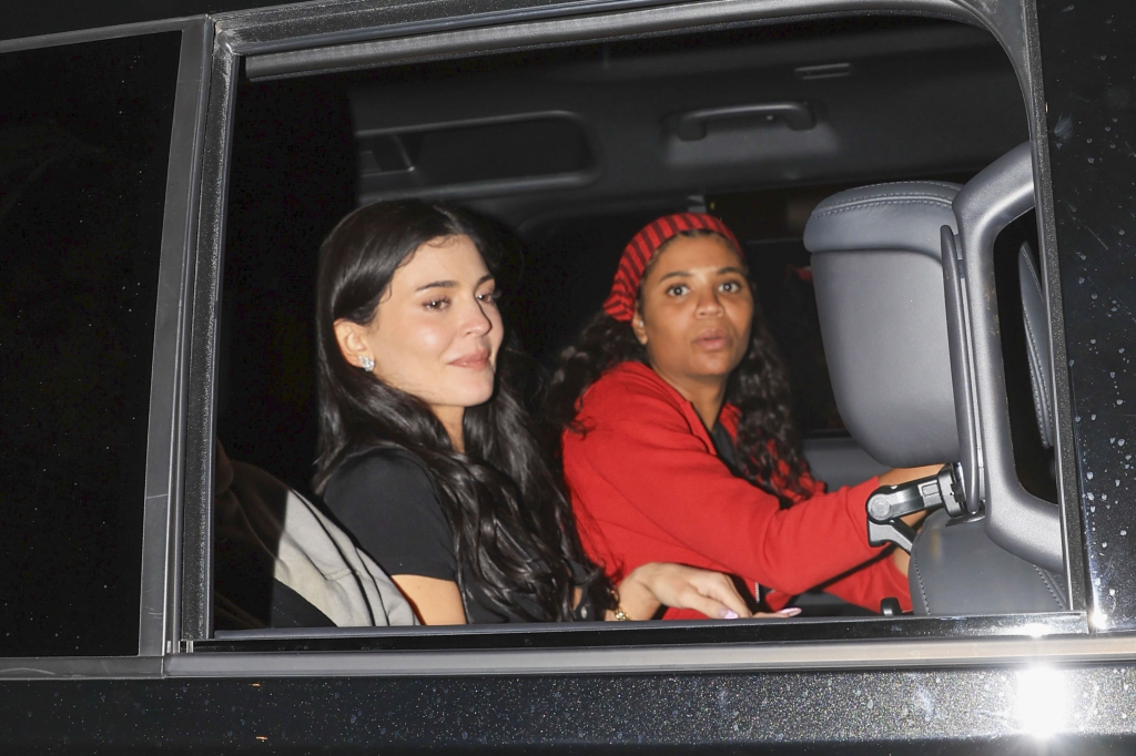 Kylie Jenner and Renell Medrano in the back of a car at night.