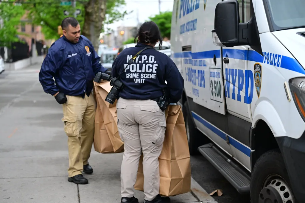 NYPD officers work a crime scene in Brooklyn, New York.