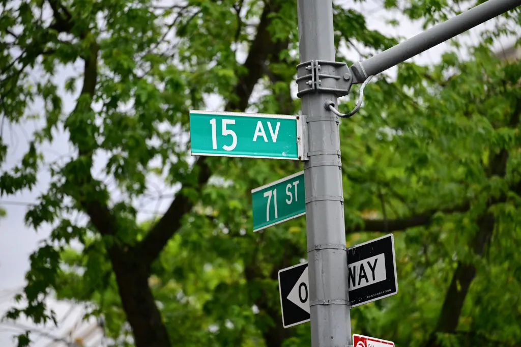 Street signs for 15th Avenue and 71st Street, with a One Way sign below, in Brooklyn, New York.