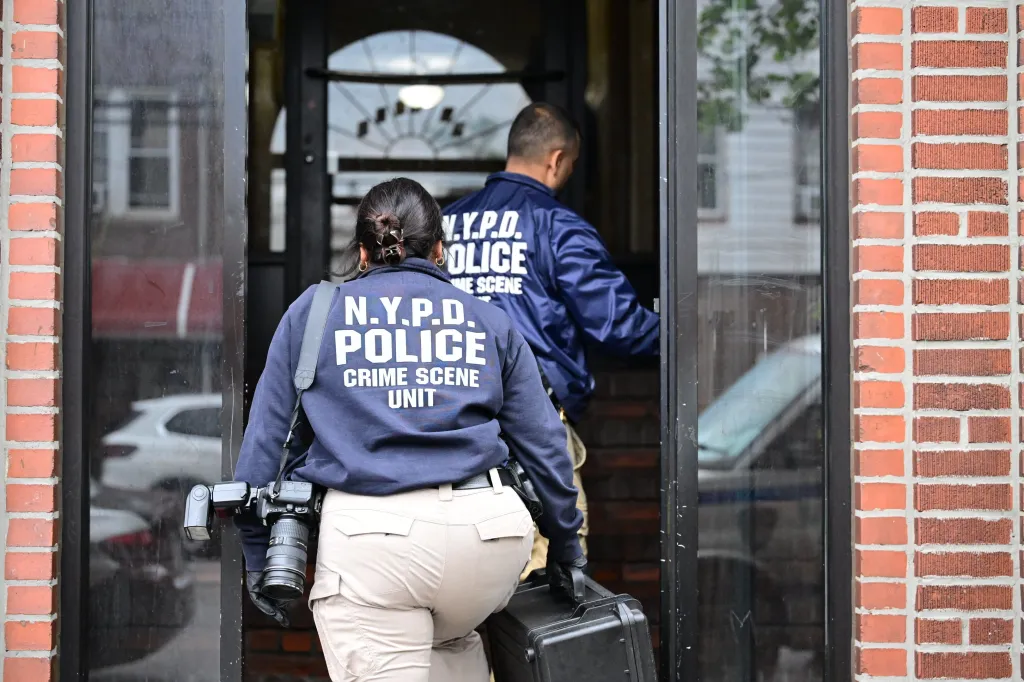 NYPD Crime Scene Unit officers enter a building on 15th Avenue and 71st Street in Brooklyn, New York, to investigate a rape.