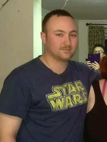 Thomas Caleb Butler, a man with short brown hair and a beard, wearing a Star Wars t-shirt.