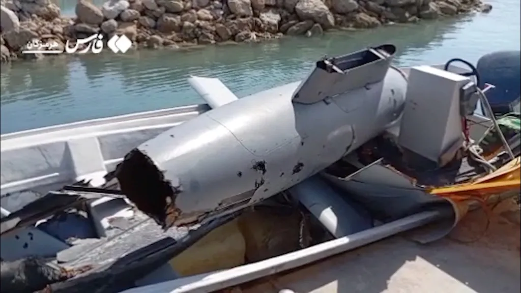 The wreckage of a drone is placed in a boat at Hormuz Island, Iran.