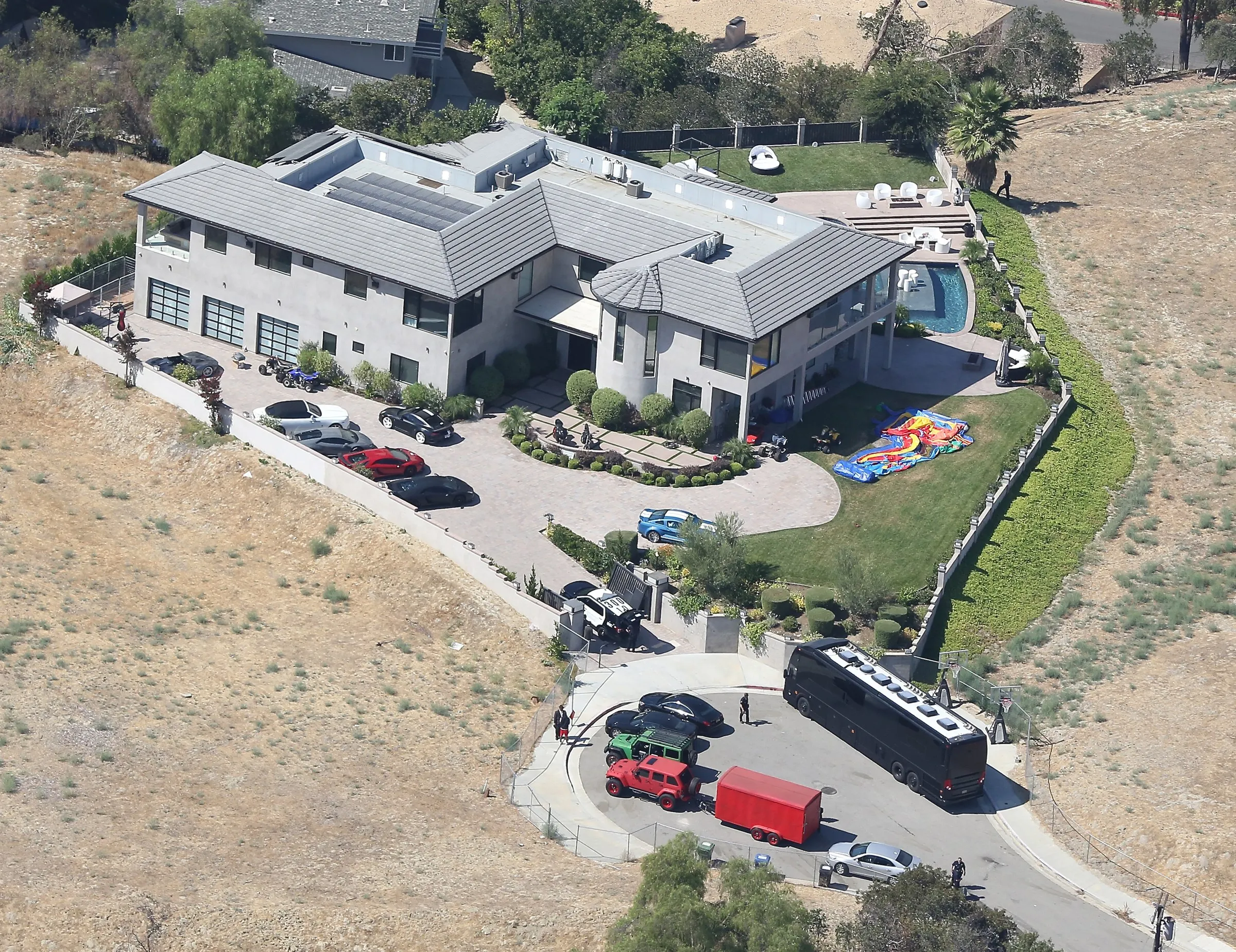 Aerial view of Chris Brown's Tarzana home, where LAPD officers and vehicles are present following a reported incident.