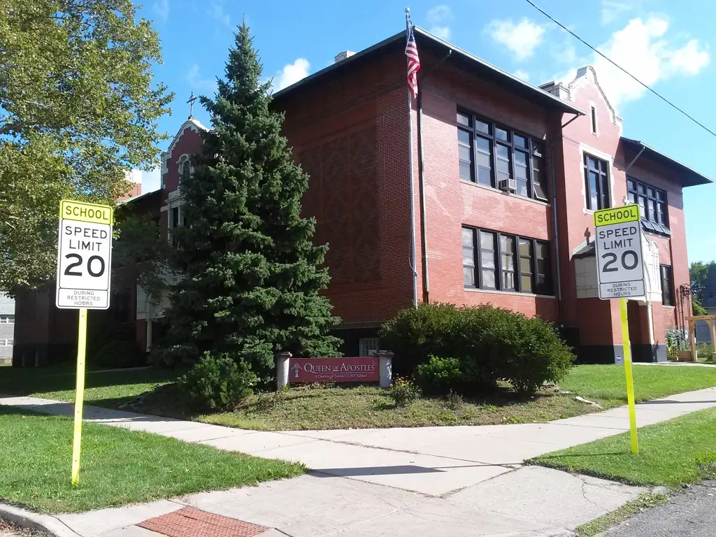The brick building of Queen of Apostles School with 