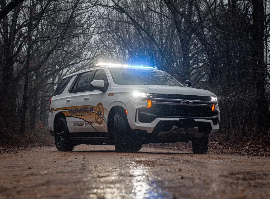 White Craighead County Sheriff's Department vehicle on a wet road.