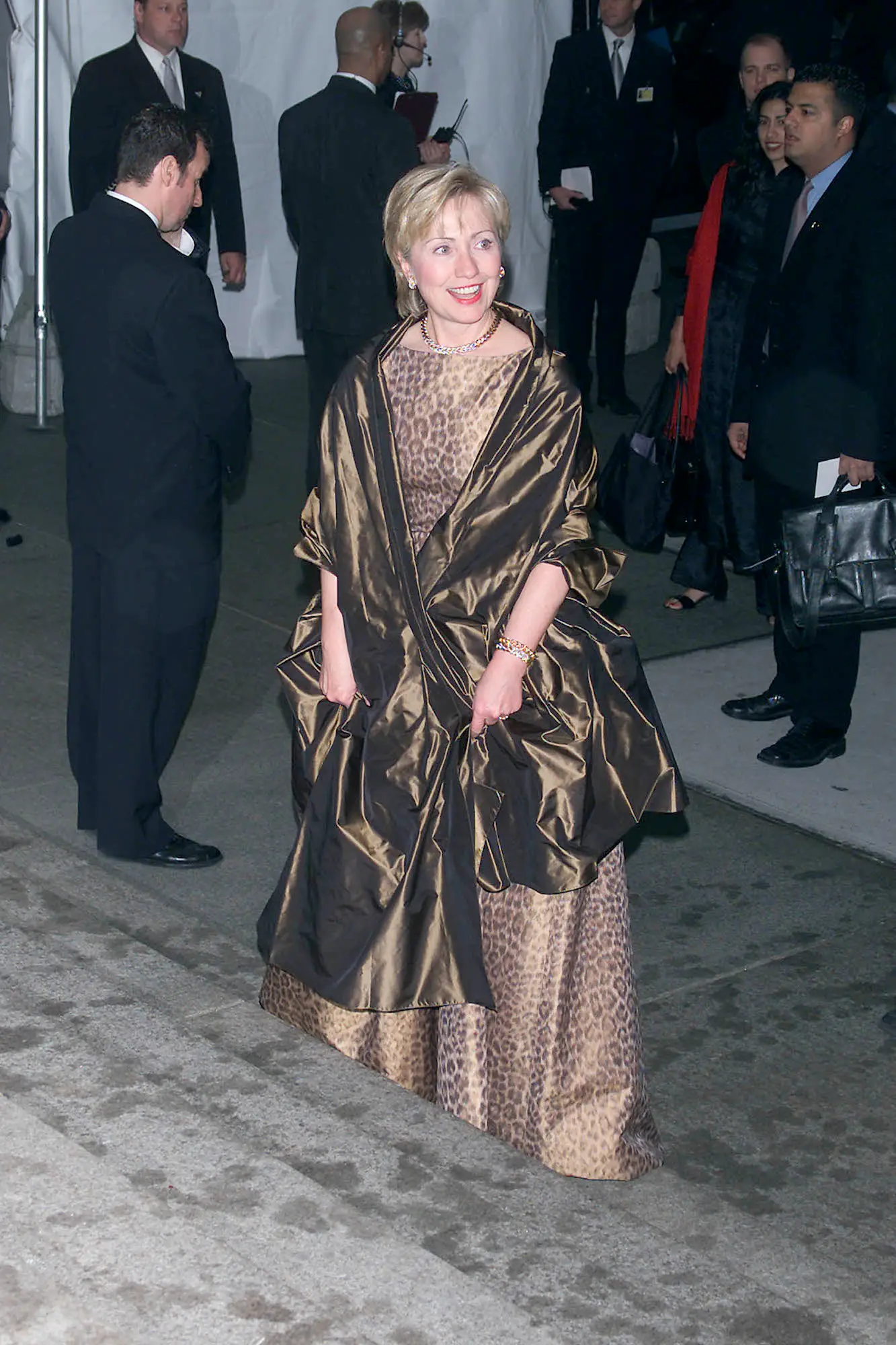 Hillary Clinton at the 2001 Met Gala wearing a brown dress with a brown shawl.