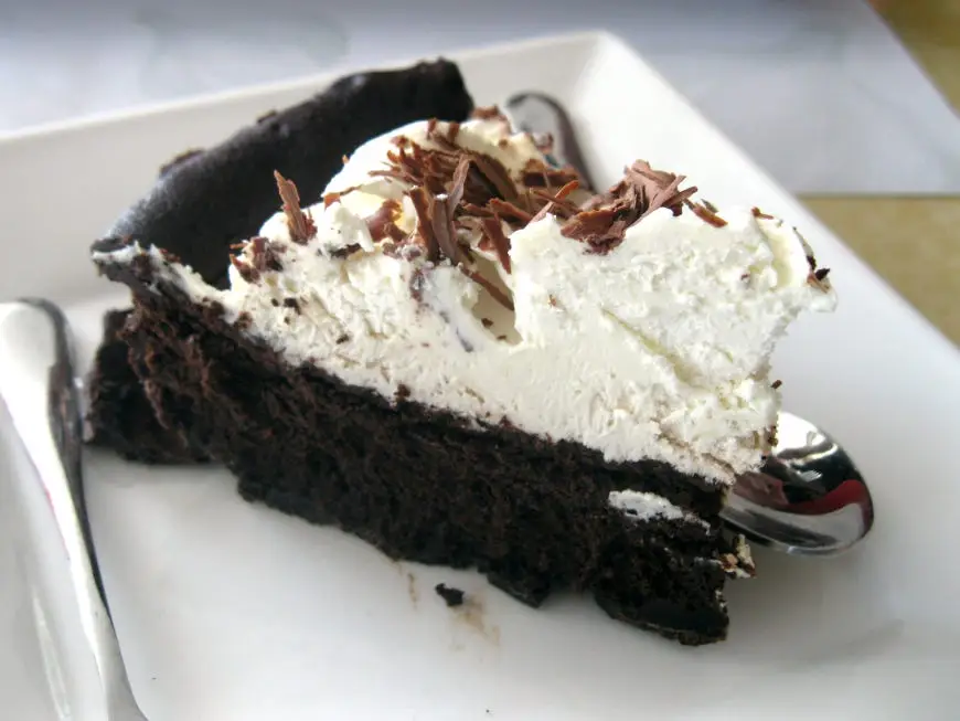 Mississippi mud pie with chocolate crust on a white plate