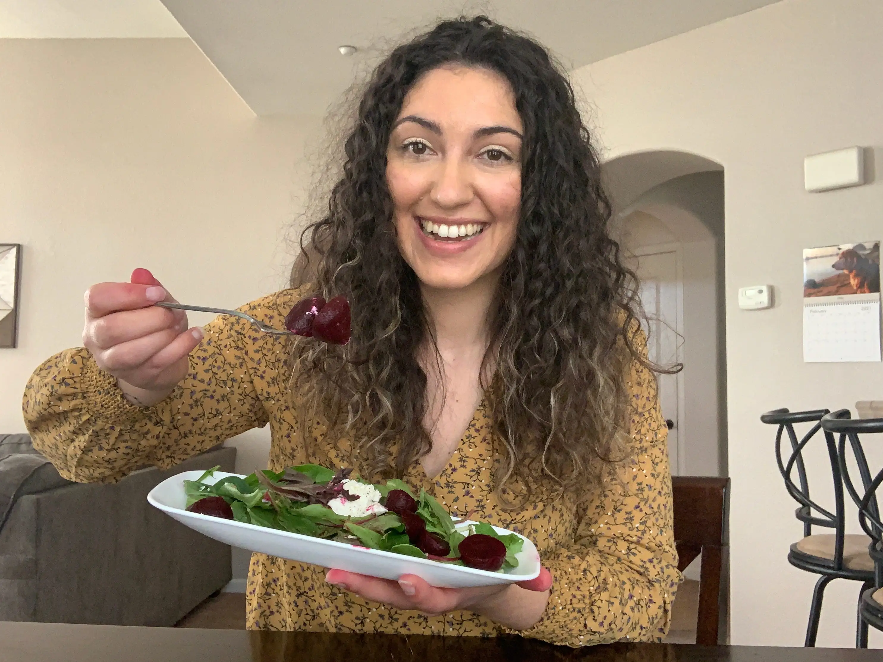 Writer holding fork while eating salad
