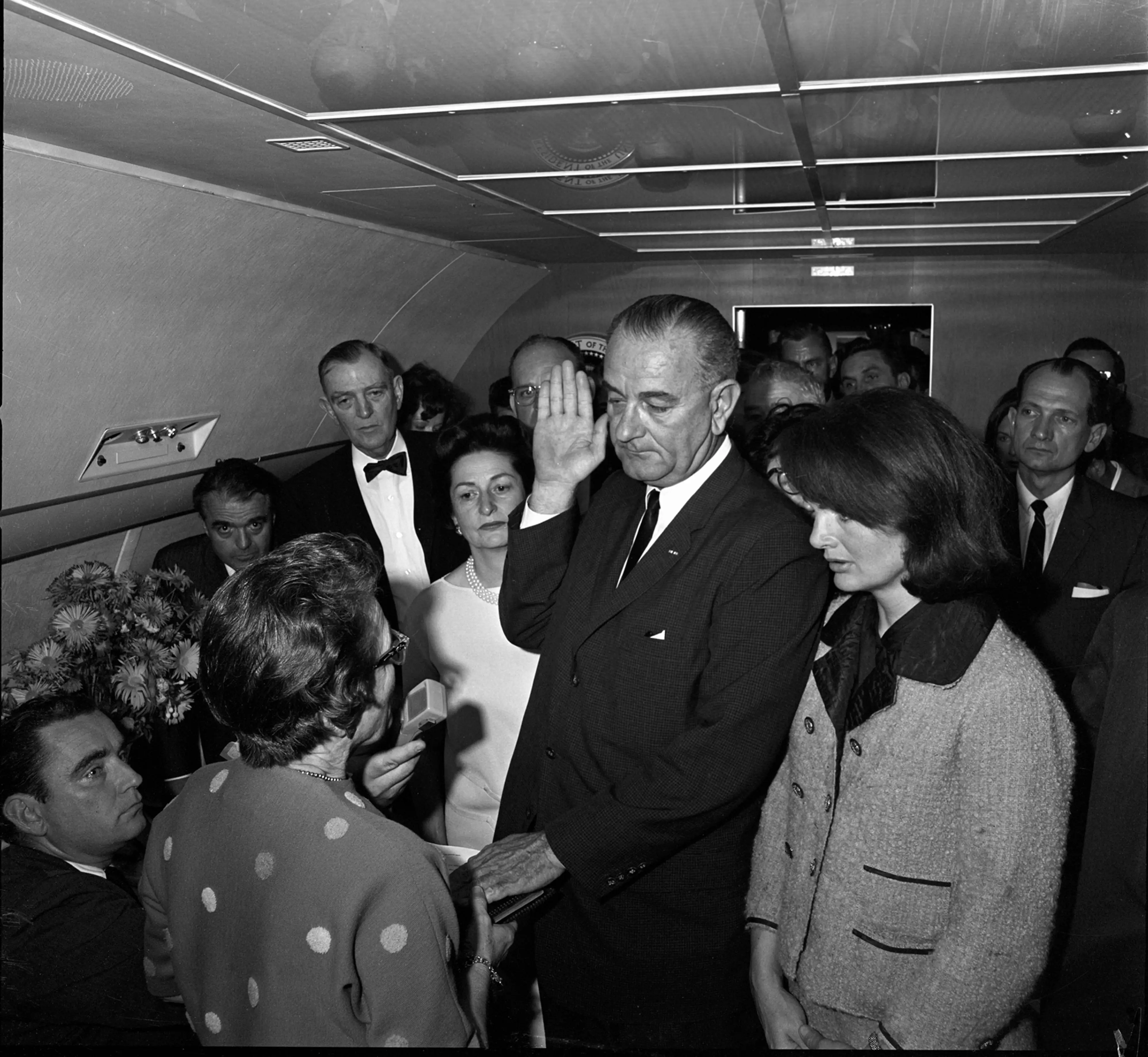 Lyndon Johnson takes the oath of office aboard Air Force One after the assassination of John F. Kennedy.