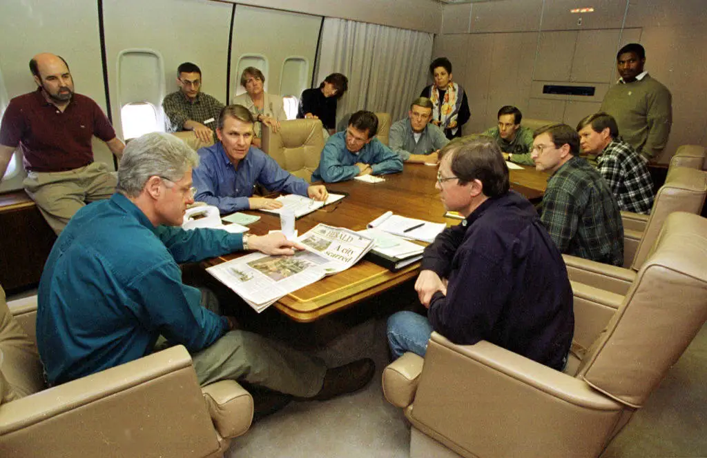 Bill Clinton meets with staff on Air Force One.