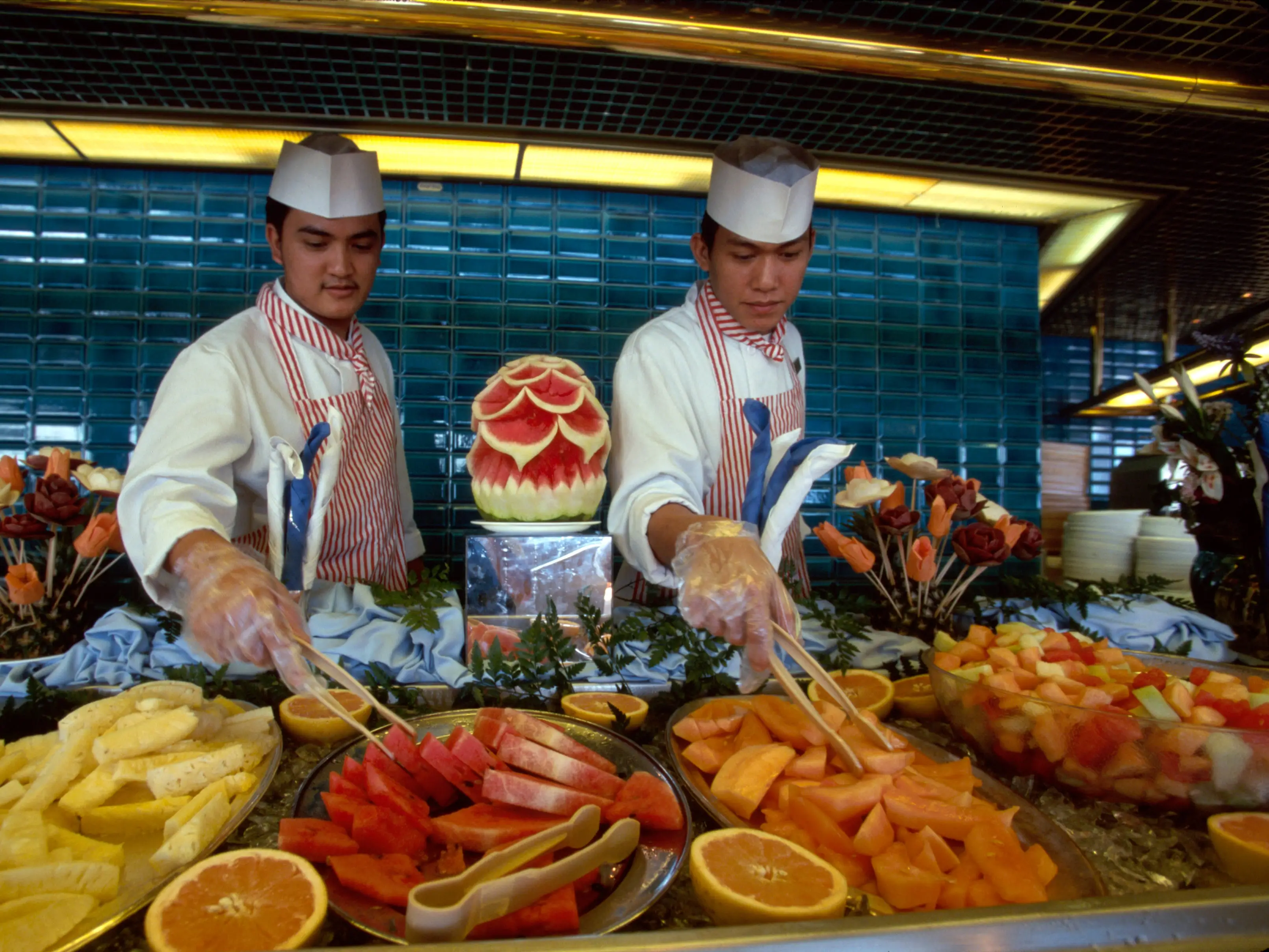 Chefs sand servers at cruise ship Buffet.