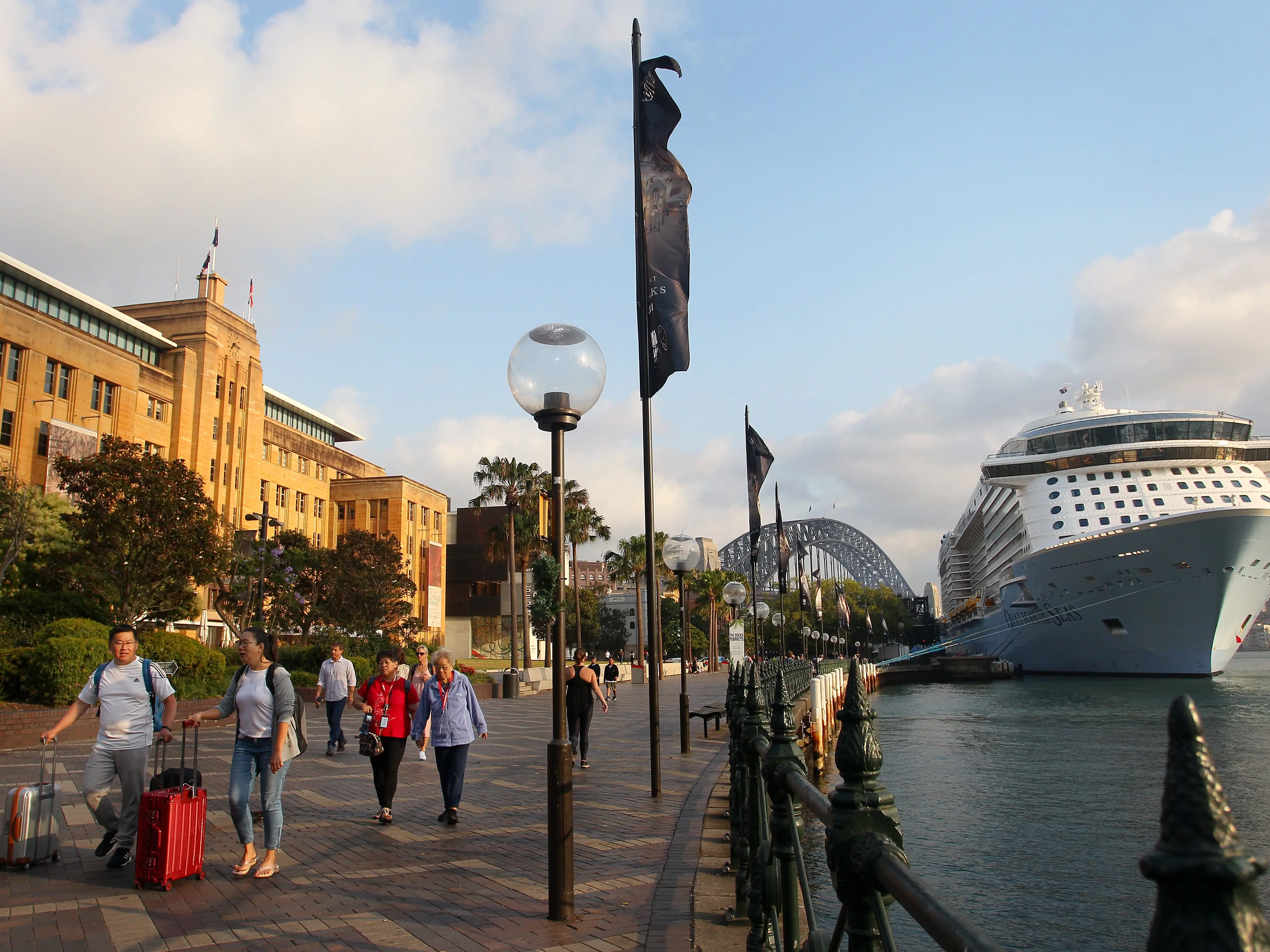 Passengers disembark the Royal Carribbean cruise ship 'Ovation of the Seas' on its return to Circular Quay in Sydney on December 16, 2019 in Sydney, Australia. Several of the ship's passengers were amongst the tourists killed at White Island when a volcano erupted on December 9, 2019, with 16 people now confirmed deceased