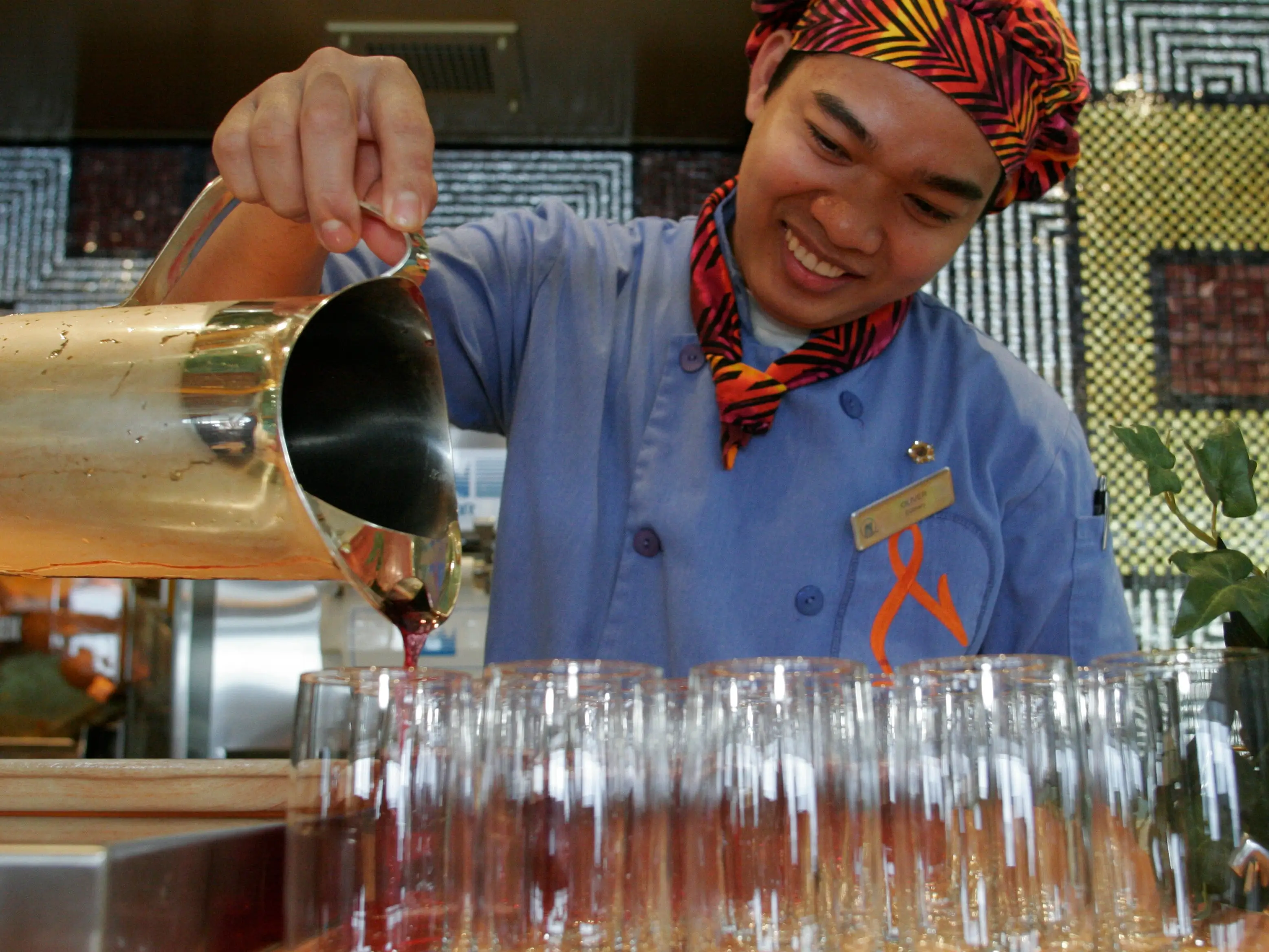 man serving drinks in the Lido Restaurant on the Holland America Caribbean cruise from New York. (Photo by: )
