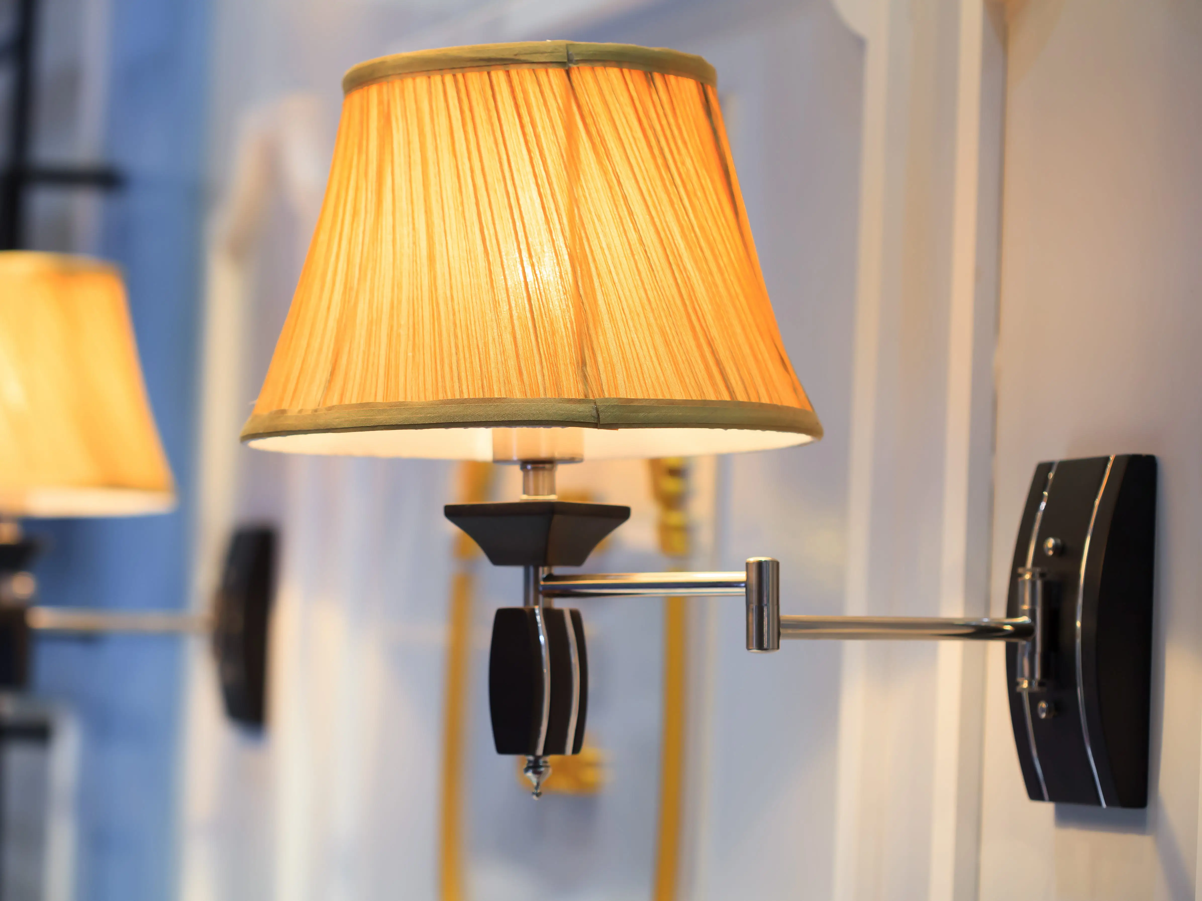 black and yellow wall sconce on white wall