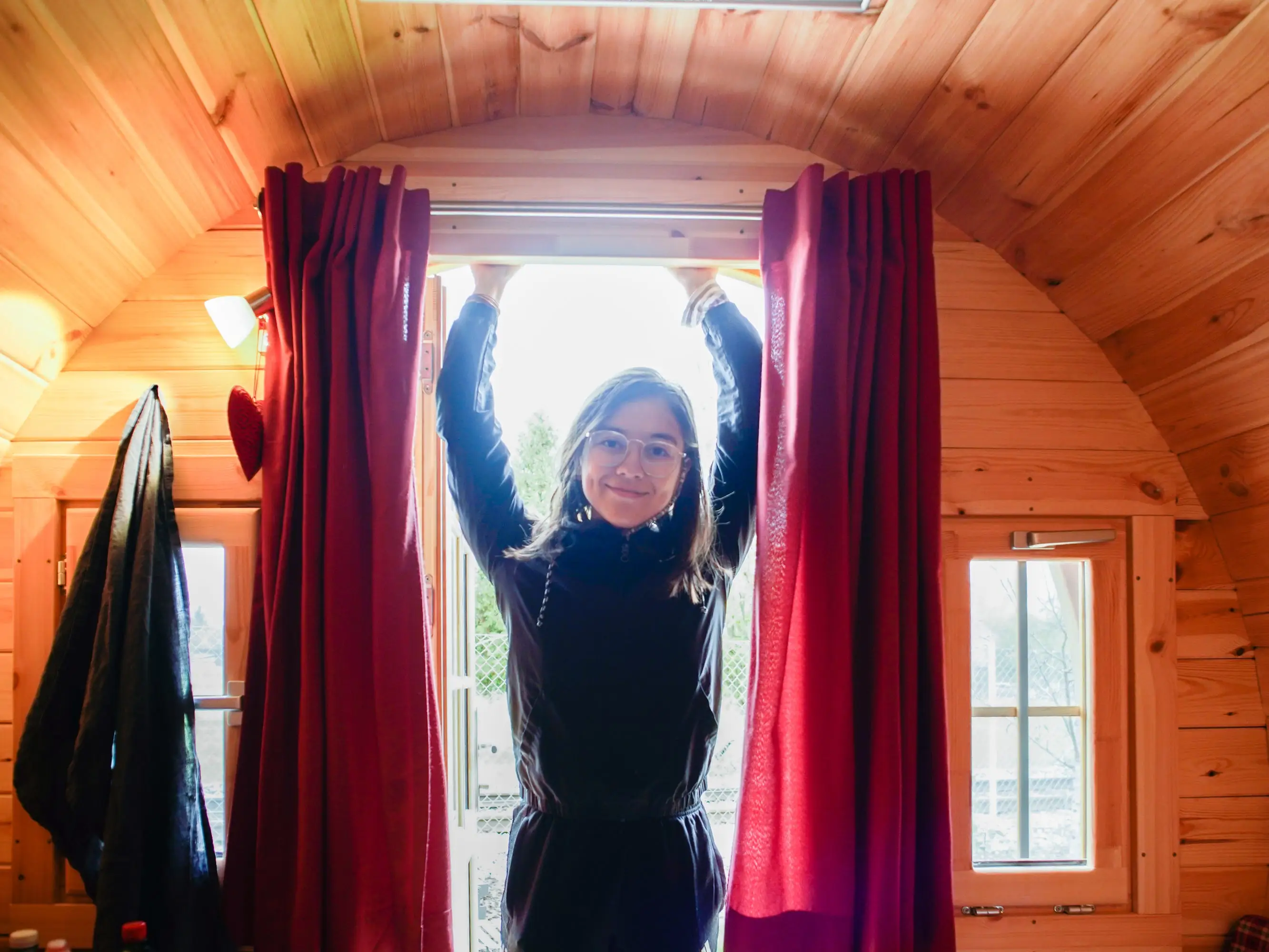 The author stands in the doorway of the barrel Airbnb