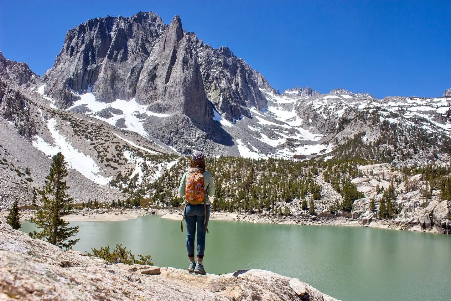nicole jones standing in front of lake with mountains in the background