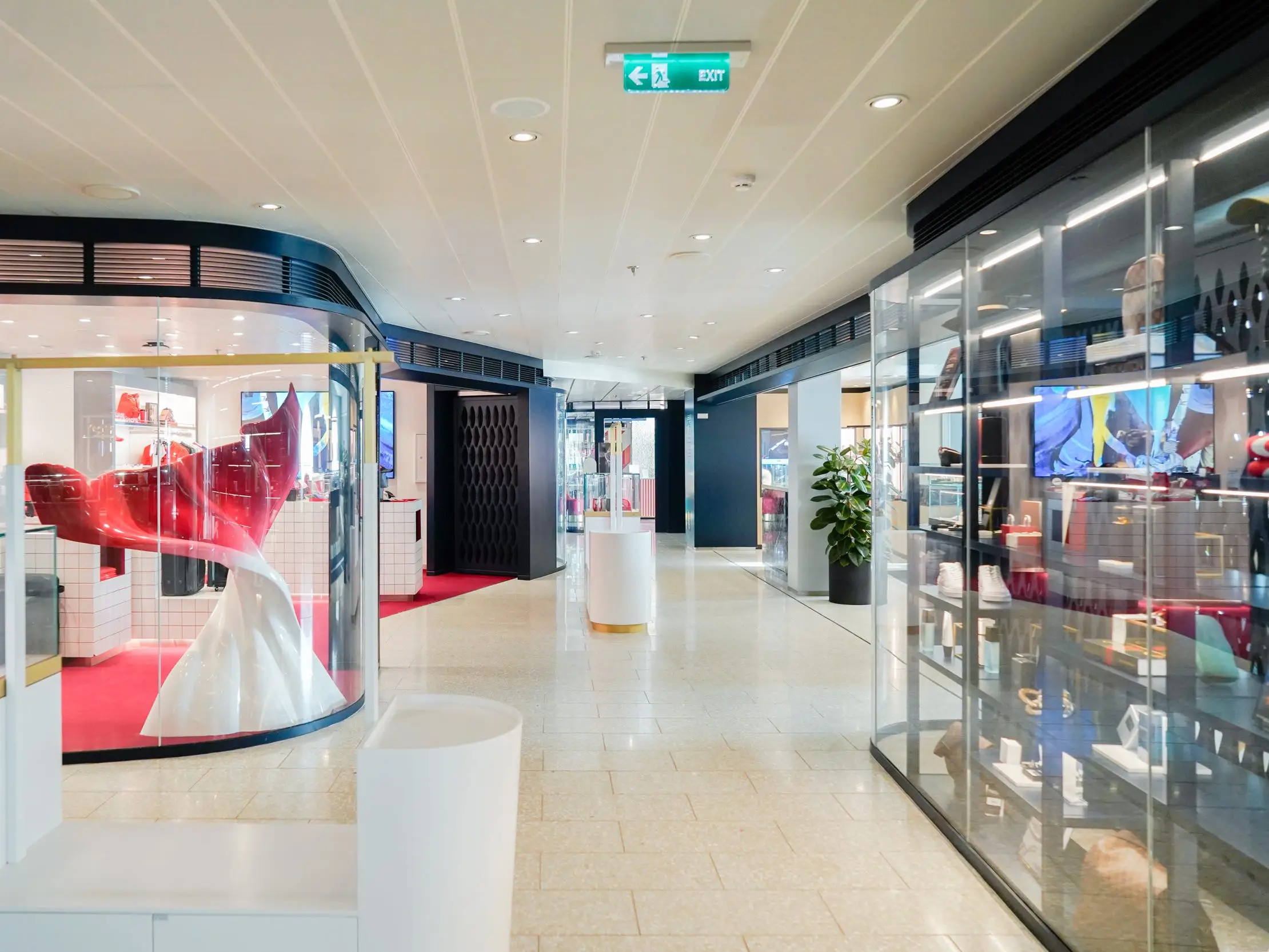 Lines of shops with floor-to-ceiling windows and white tile flooring
