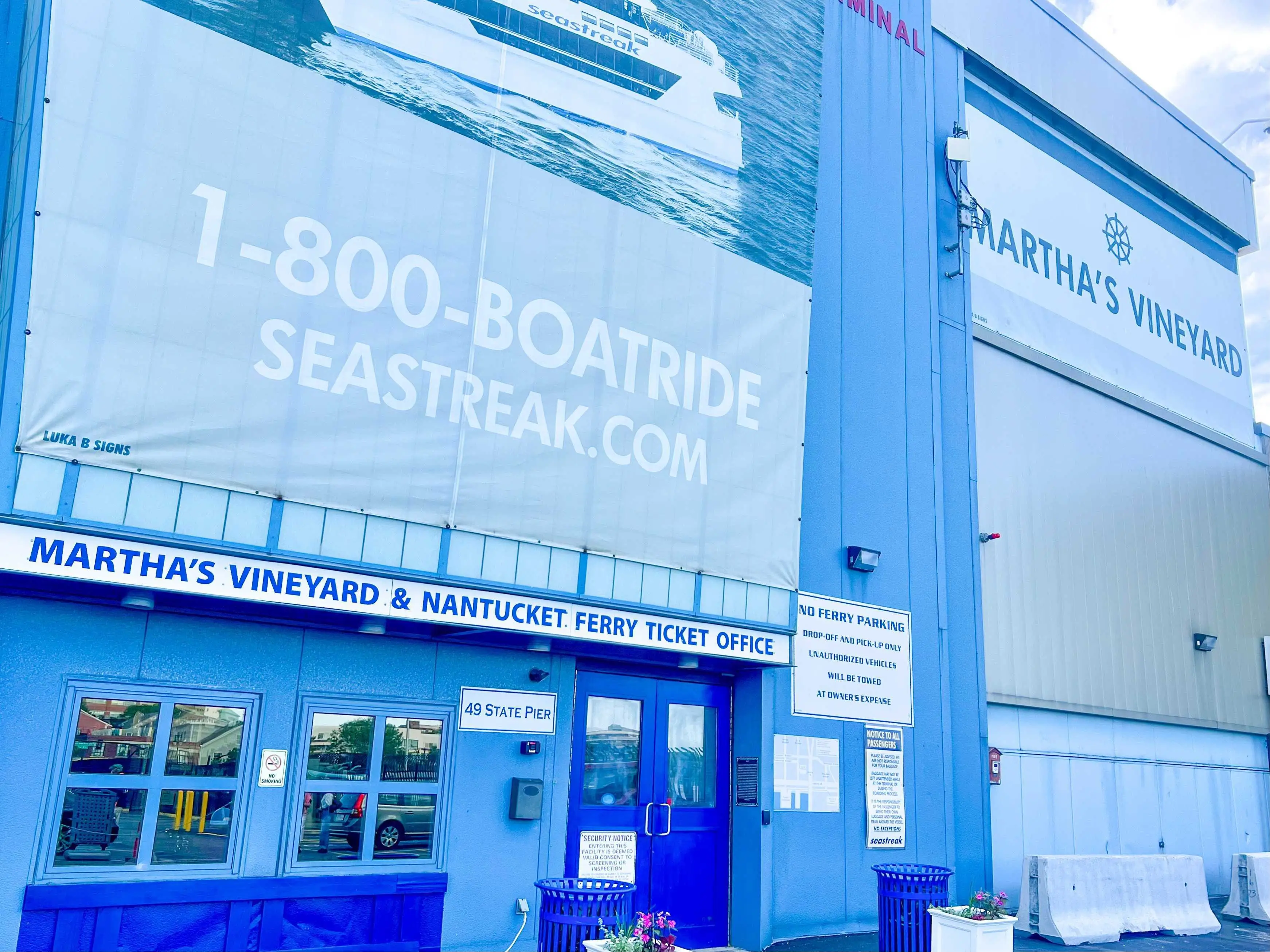 Martha's Vineyard ferry terminal, which is a blue building with dark-blue doors and a light-blue sign that says 