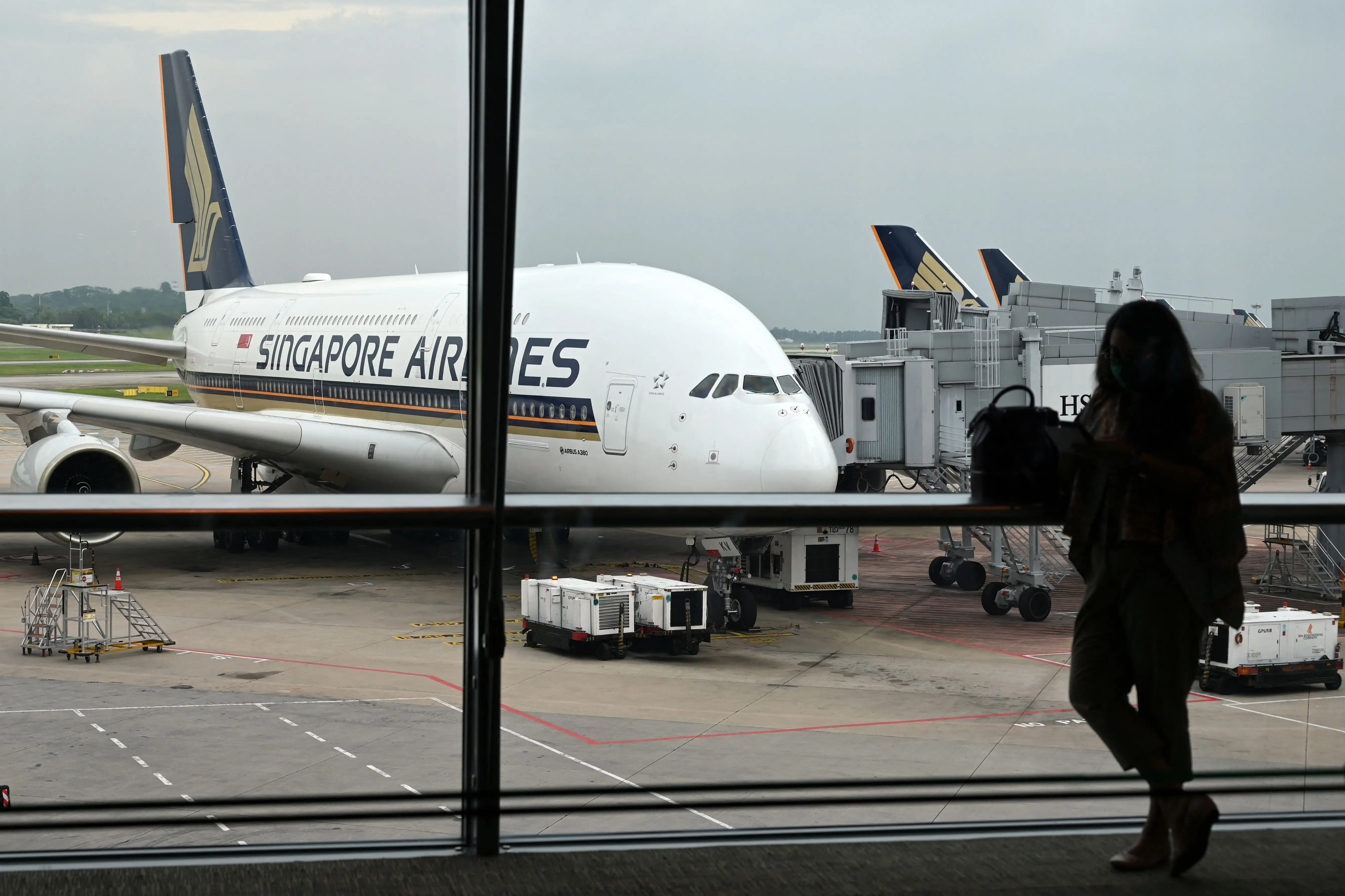 A Singapore Airlines plane parked on the tarmac at Singapore Changi Airport.