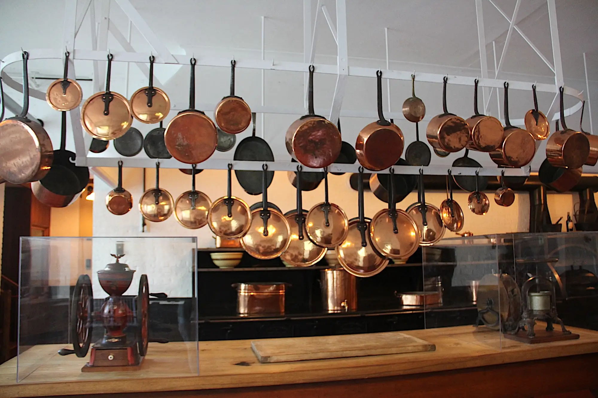 The kitchen at Marble House with copper pots hanging from the ceiling.