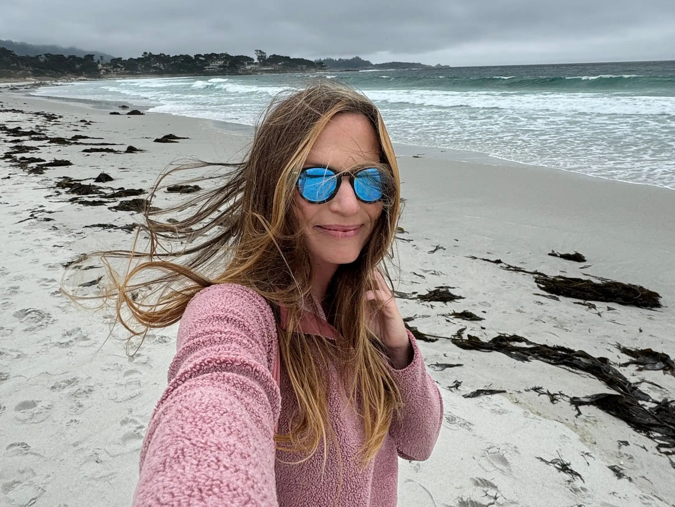 Emily taking a selfie at a beach in Carmel-by-the-Sea.