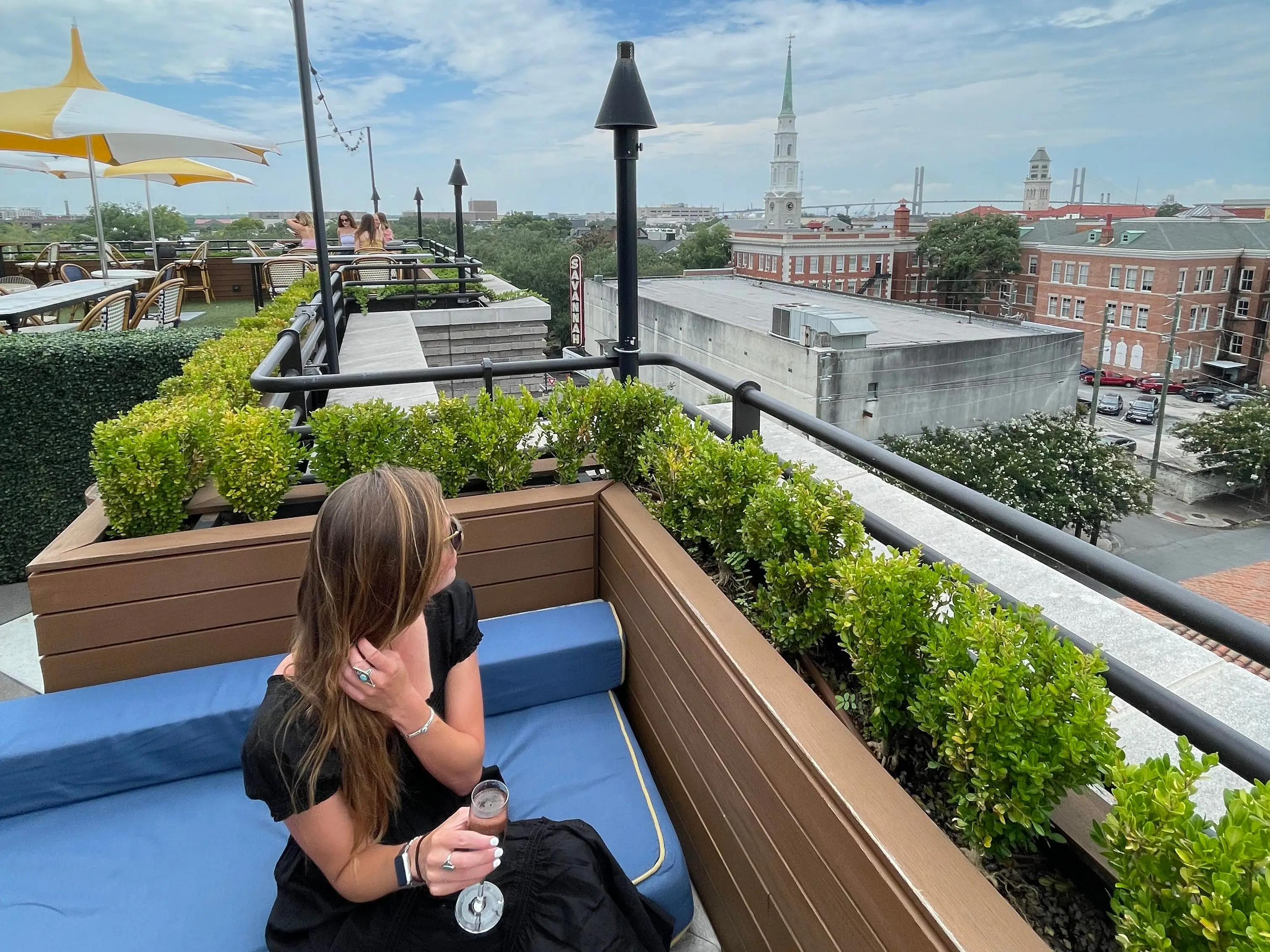 Emily sitting on a rooftop overlooking Savannah, Georgia.