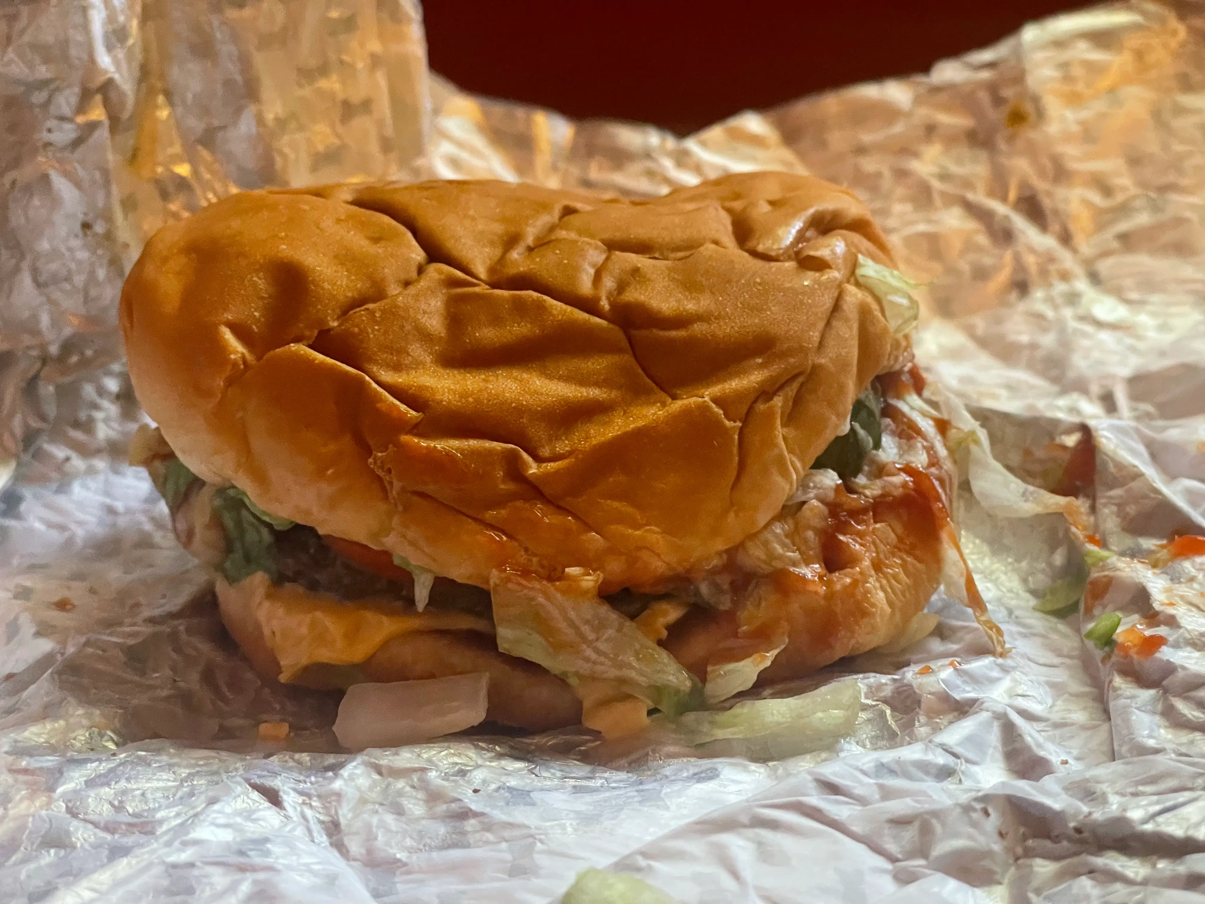 A cheeseburger on the paper it was wrapped in.
