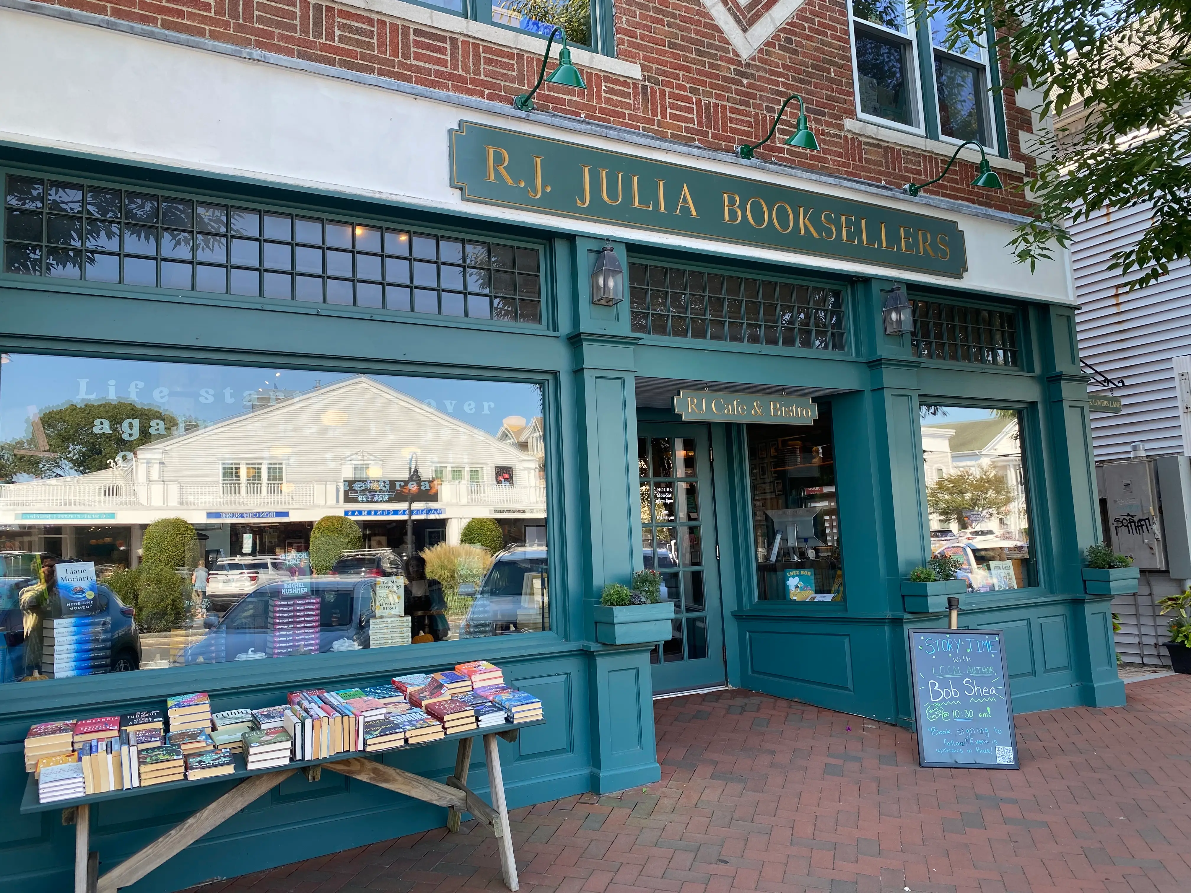 RJ Julia Bookseller's exterior with table of books out front on the brick sidewalk.