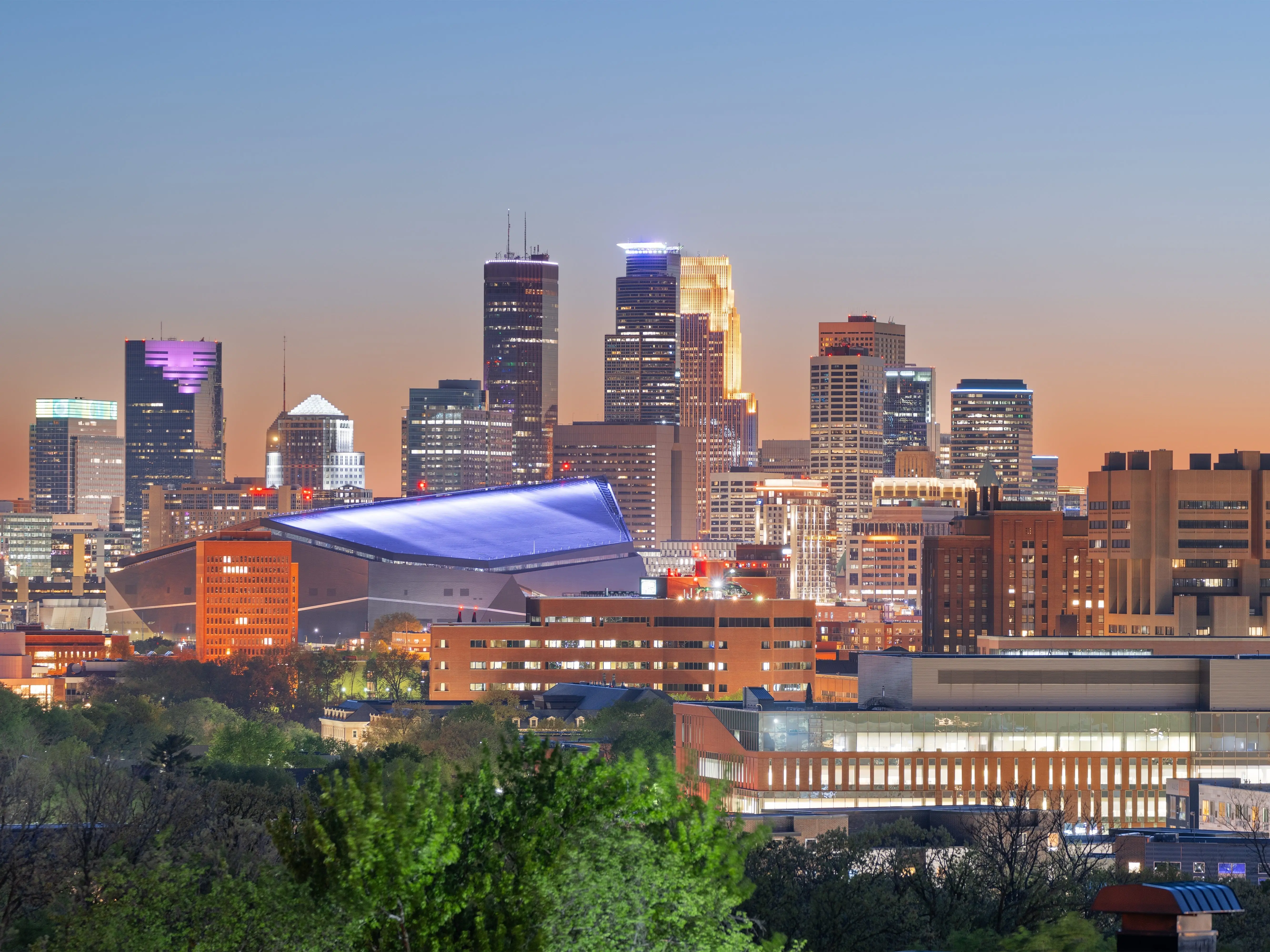 Downtown Minneapolis skyline at dusk with US Bank Stadium in view.